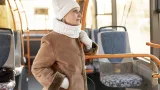 Front view senior female riding bus petit